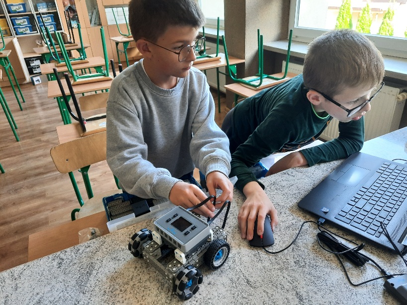 dwóch uczniów podczas budowania robota z klocków VEX IQ